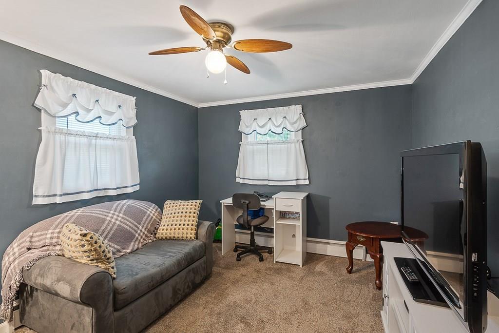 24 Springwell Road Billerica, MA 01821 - Photo 8 of 16 a living room with furniture and a flat screen tv