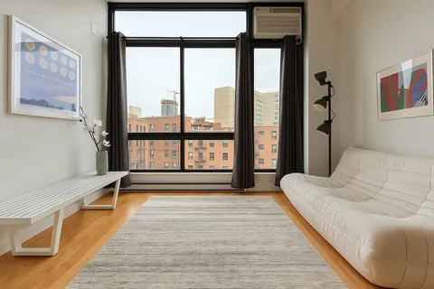 a spacious bedroom with a large bed and a large window