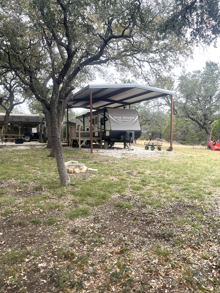 695 Big Shades Road Concan, TX 78838 - Photo 21 of 27 a view of a yard with a tree