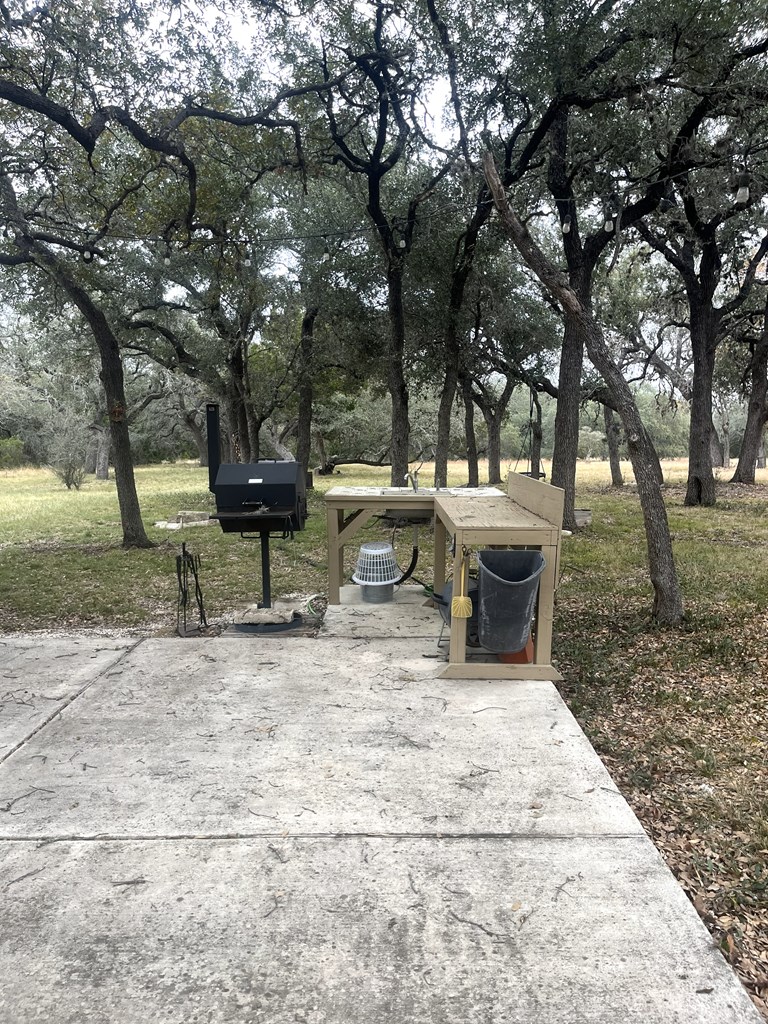 695 Big Shades Road Concan, TX 78838 - Photo 22 of 27 a view of a house with backyard and sitting area