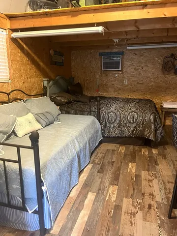 a bed with a black white bedspread and pillows