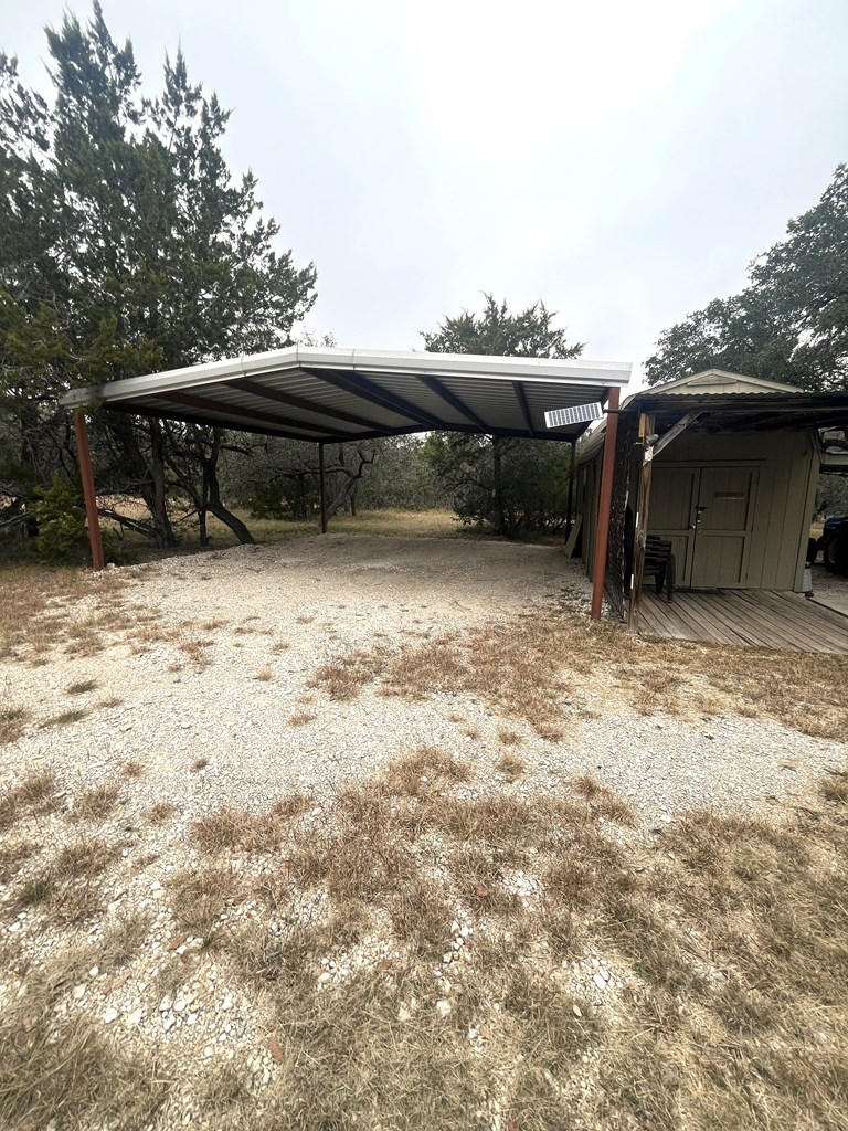 695 Big Shades Road Concan, TX 78838 - Photo 7 of 27 a front view of a house with a yard