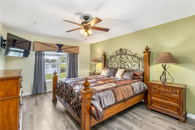 a bedroom with a bed and a chandelier