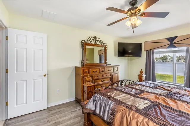 a bedroom with a bed a window and a television