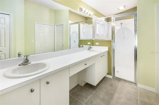 a bathroom with a double vanity sink mirror and double