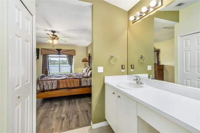 a en suite bathroom with a double vanity sink a mirror and shower