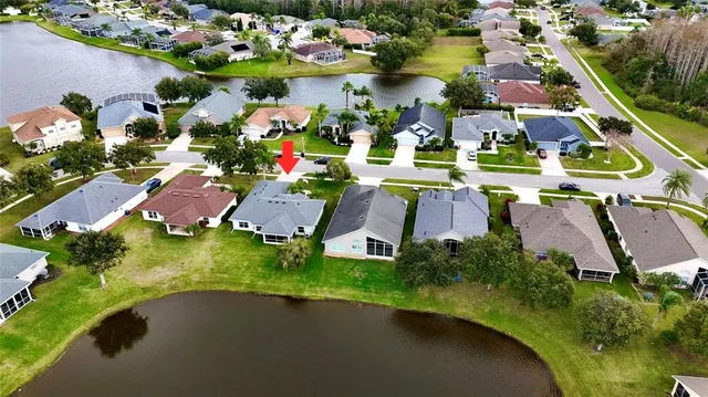 an aerial view of residential houses with outdoor space and swimming pool