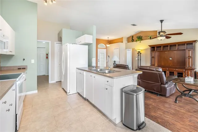 a large white kitchen with a large window