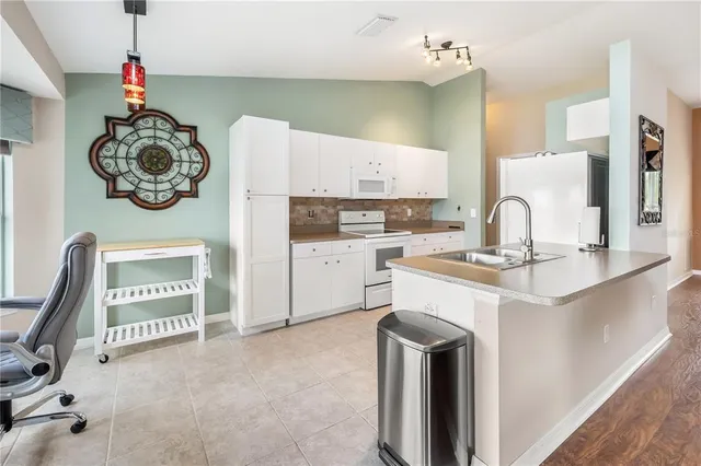 a kitchen with a sink a stove and a refrigerator