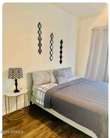 a bedroom with a bed and a window