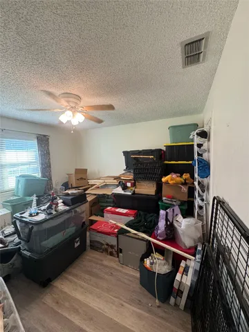 a bedroom with furniture and a wooden floor