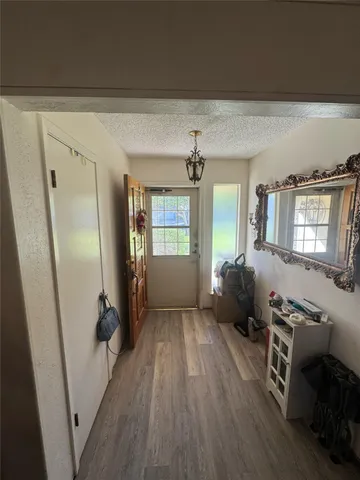 a view of a livingroom with furniture hardwood floor and a ceiling fan