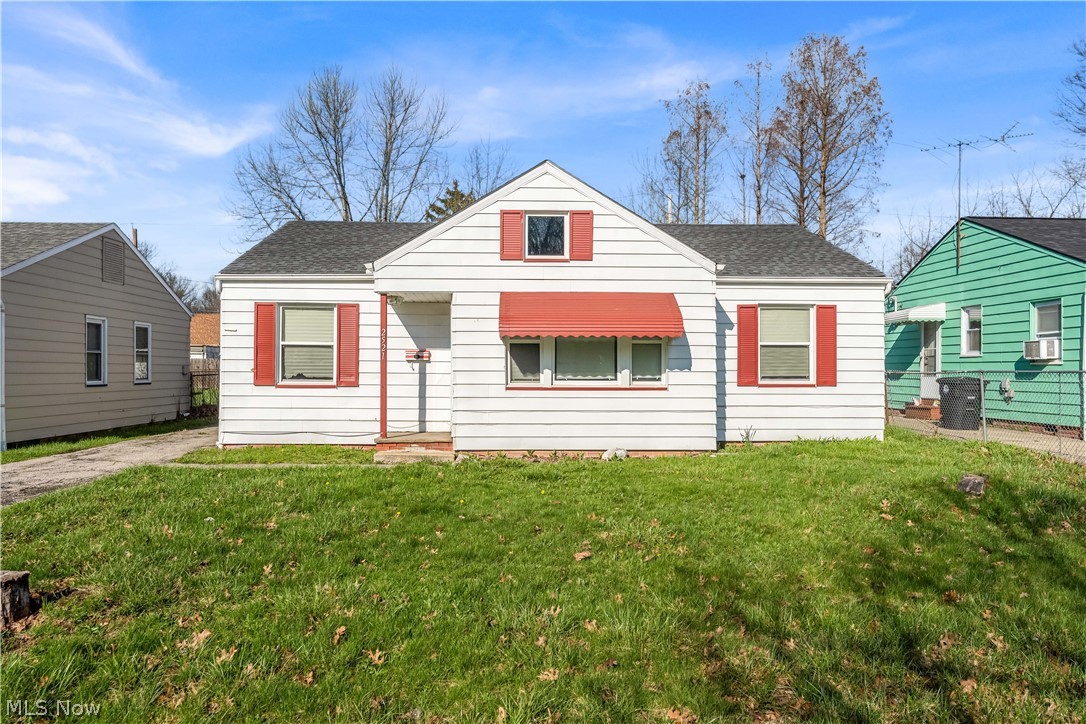 2521 Greenvale Road Cleveland, OH 44121 - Photo 1 of 23 White siding residence featuring red window awnings and shutters