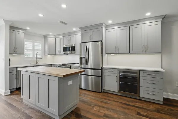 a kitchen with a refrigerator and a stove top oven