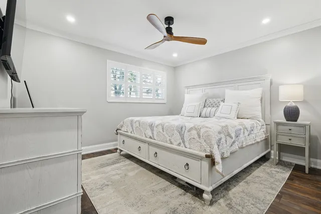 a bedroom with a large bed and a chandelier