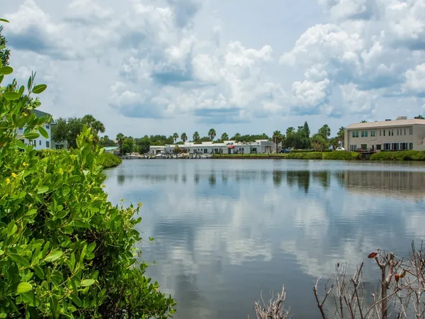 a view of a lake with houses in the back