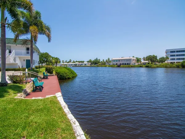 a view of a lake with houses in the back
