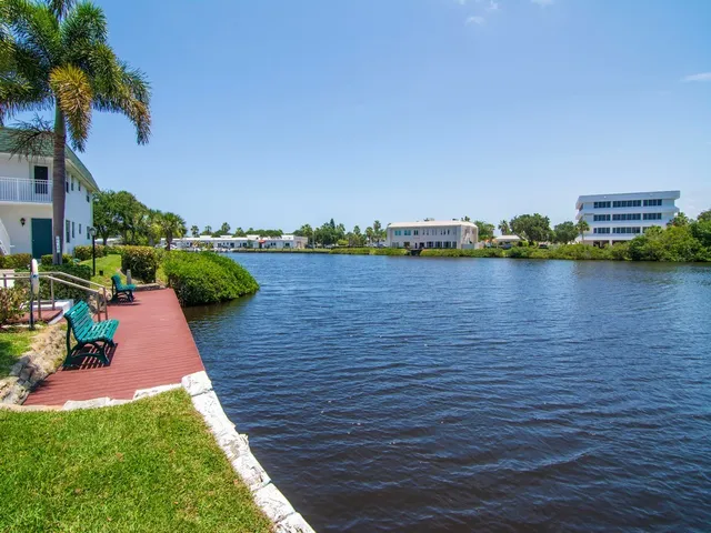 a view of a lake with houses in the back