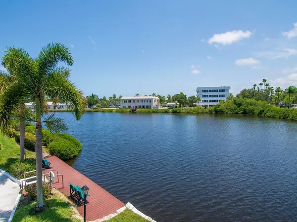 a view of a lake with houses in the back
