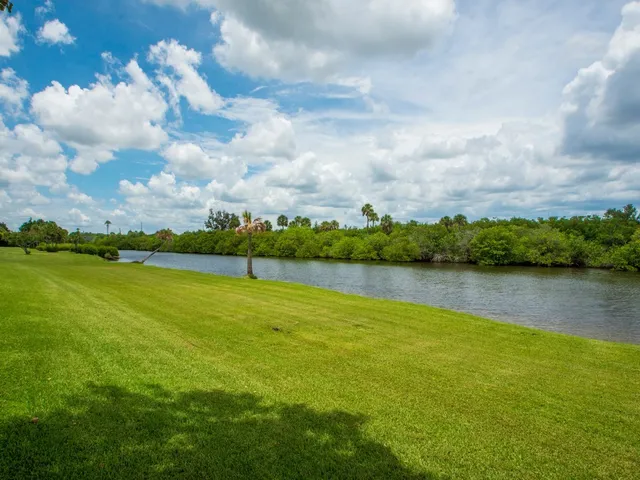 a view of a lake and houses in the back