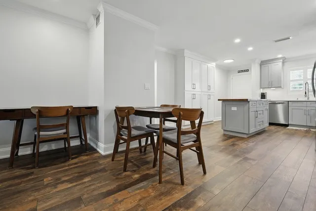 a view of a dining room with furniture and wooden floor