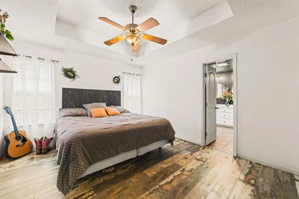 a bedroom with a bed and a chandelier