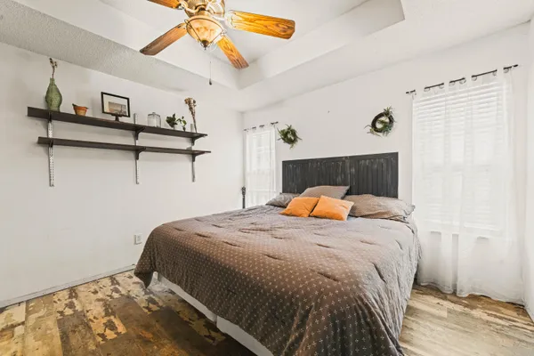 a bedroom with a bed and painting on the wall