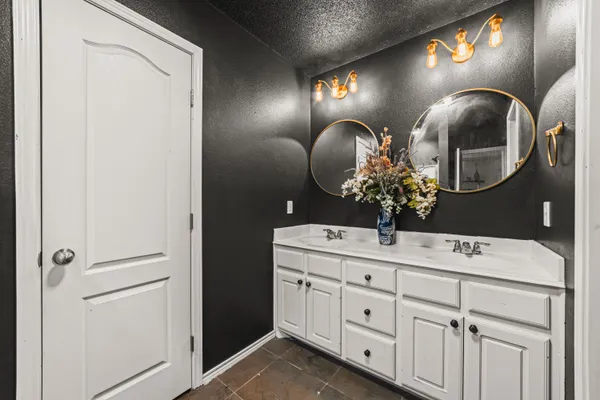 a bathroom with a mirror and vanity