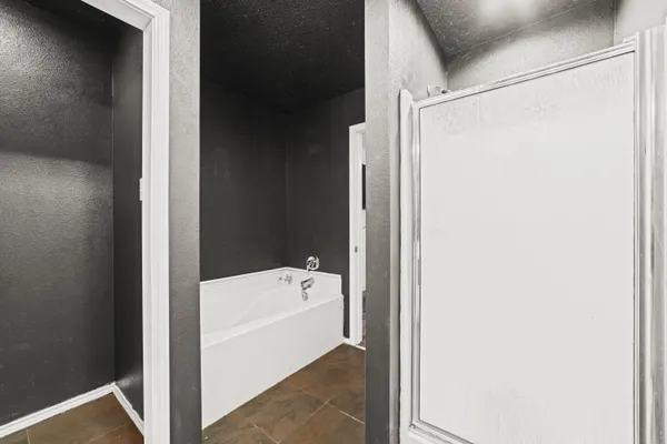 a bathroom with a bathtub and a shower