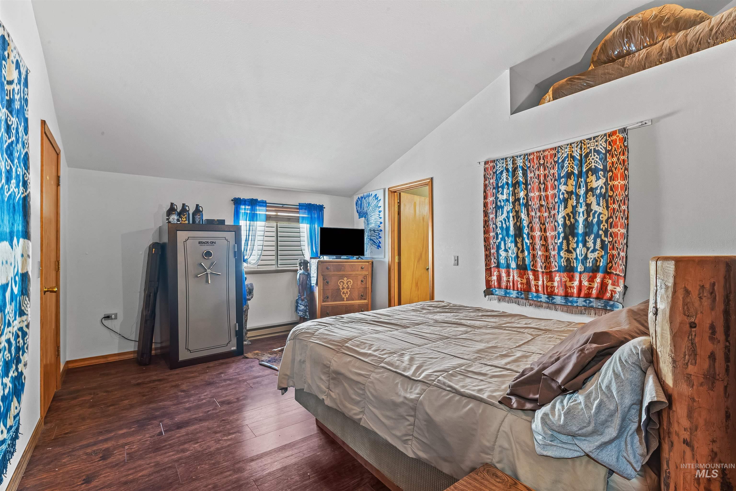 302 Berger Street Riggins, ID 83549 - Photo 12 of 47 Bedroom featuring vaulted ceiling and wood finished floors
