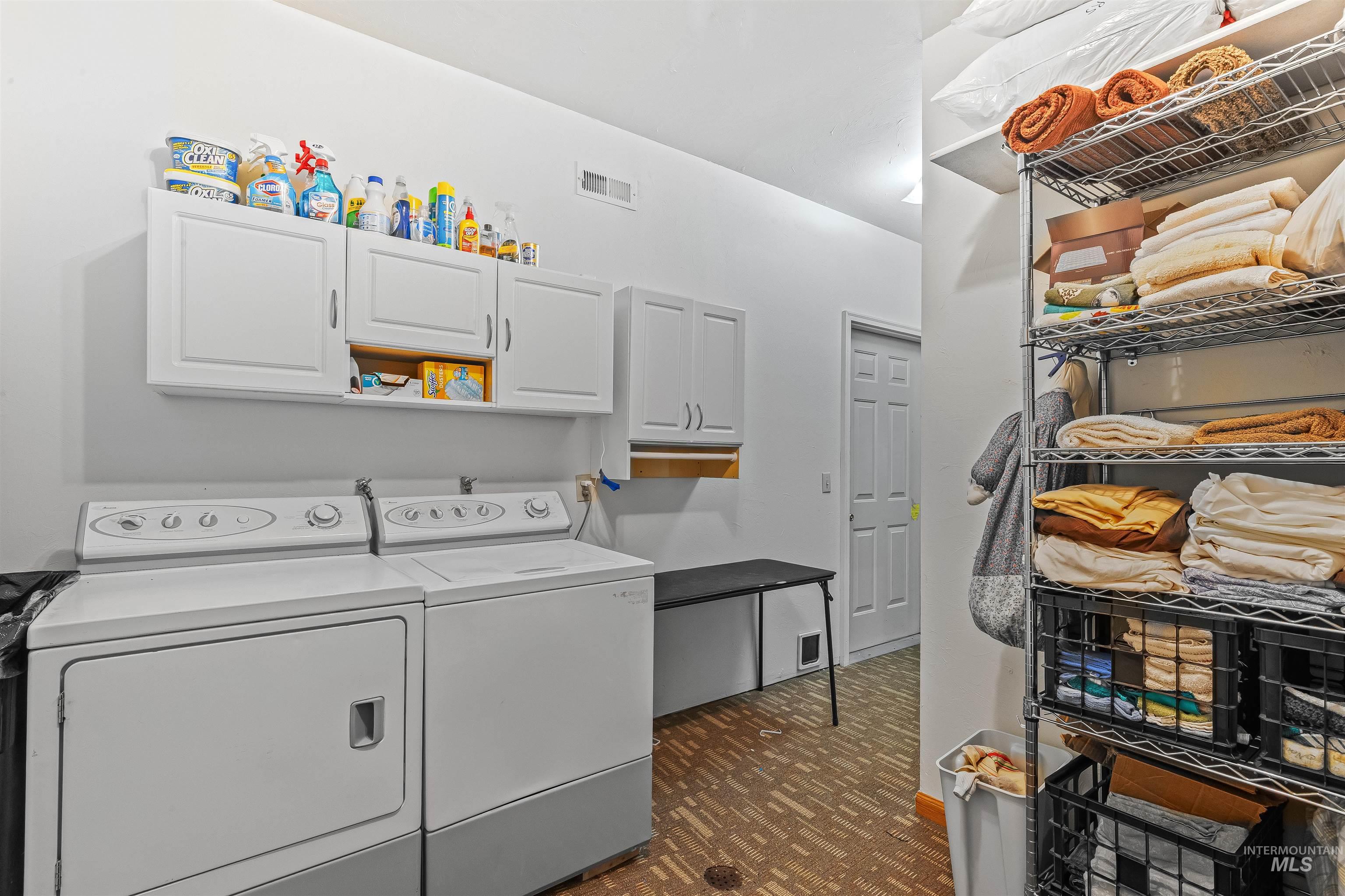302 Berger Street Riggins, ID 83549 - Photo 14 of 47 Laundry room featuring cabinet space, washing machine and dryer, and dark floors