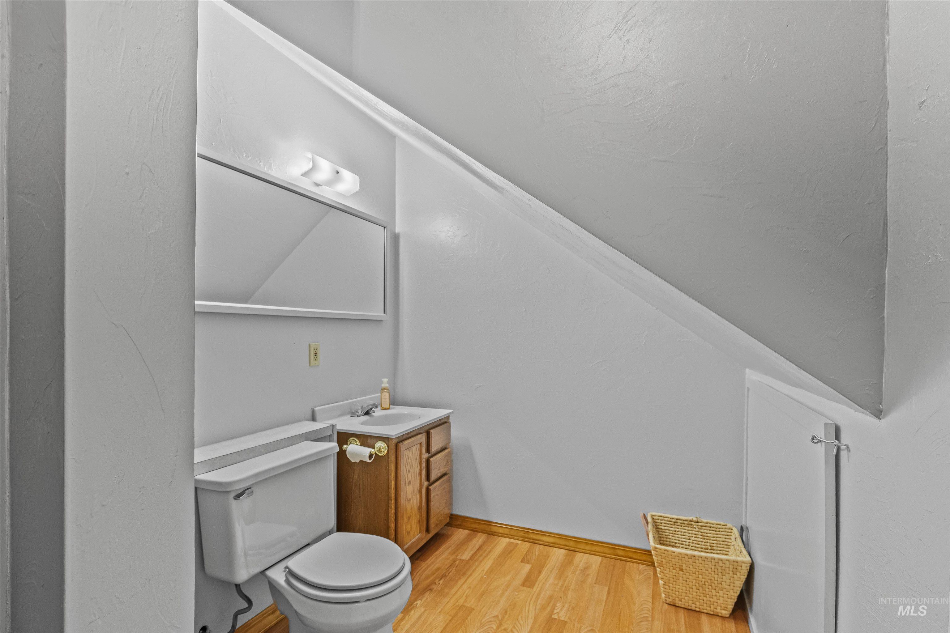 302 Berger Street Riggins, ID 83549 - Photo 15 of 47 Half bath featuring wood finished floors and vanity