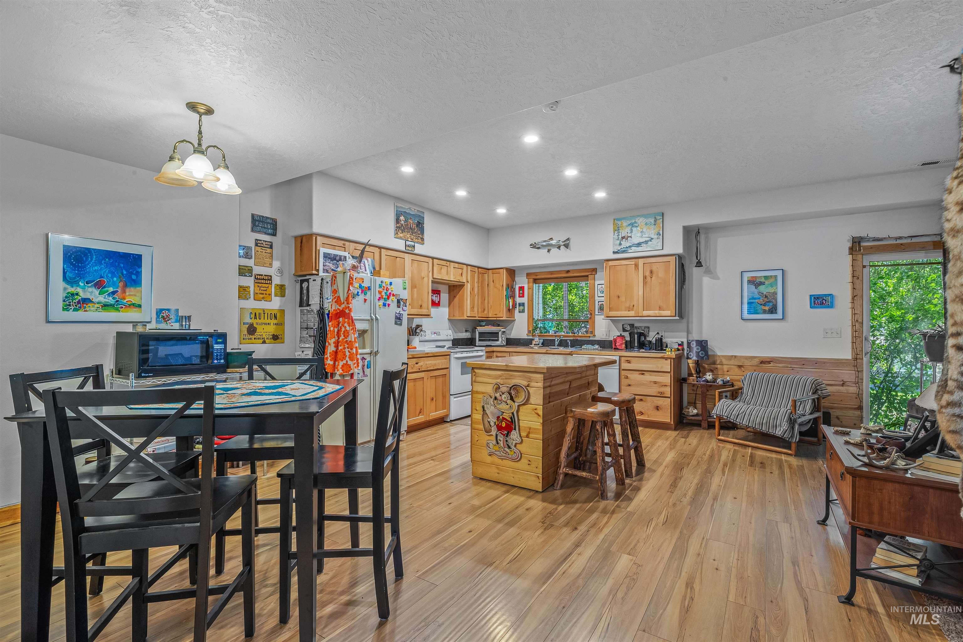 302 Berger Street Riggins, ID 83549 - Photo 32 of 47 Kitchen featuring white appliances, light wood finished floors, a textured ceiling, light countertops, and recessed lighting