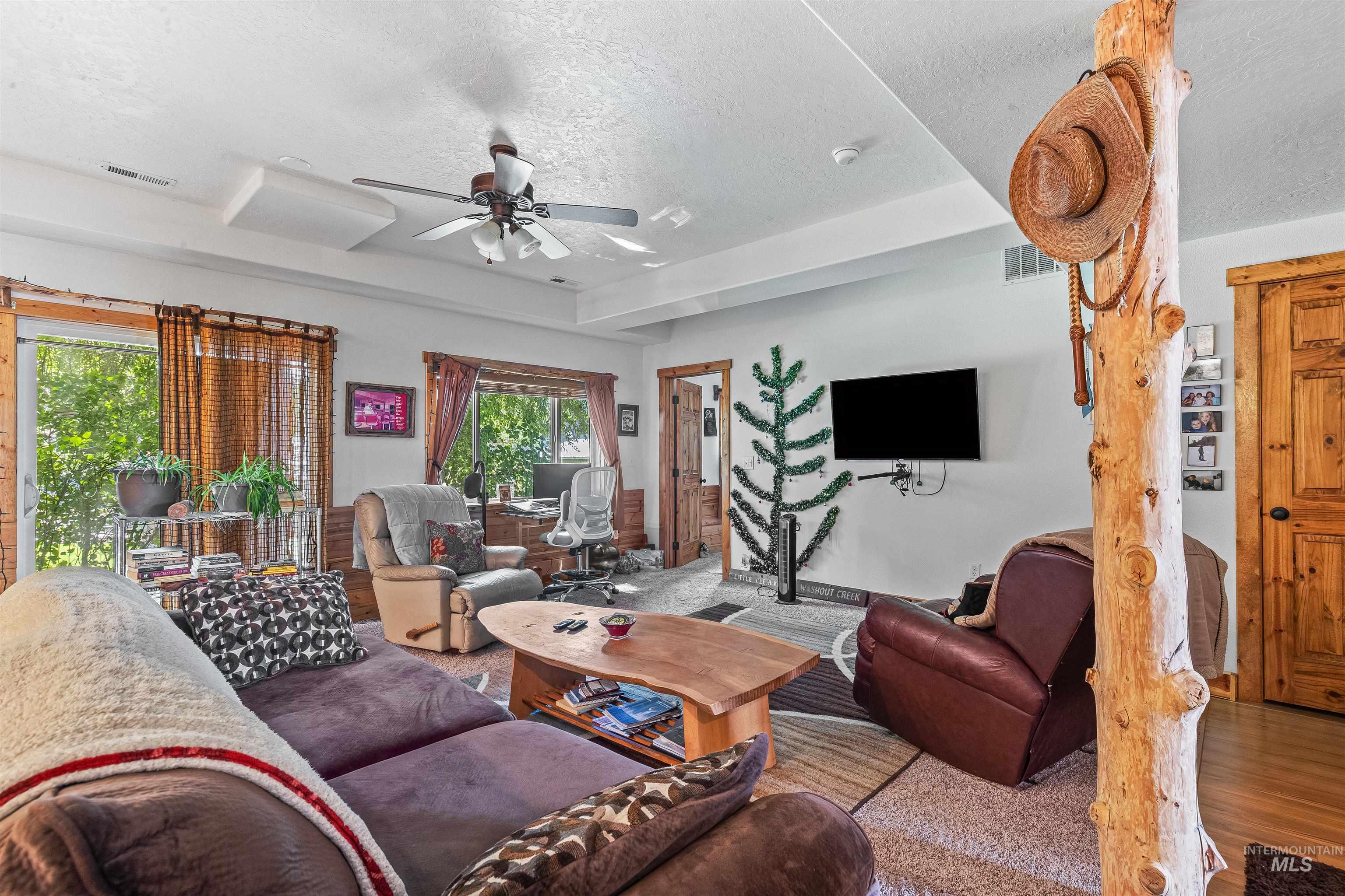 302 Berger Street Riggins, ID 83549 - Photo 34 of 47 Living room featuring a textured ceiling, ceiling fan, and wood finished floors