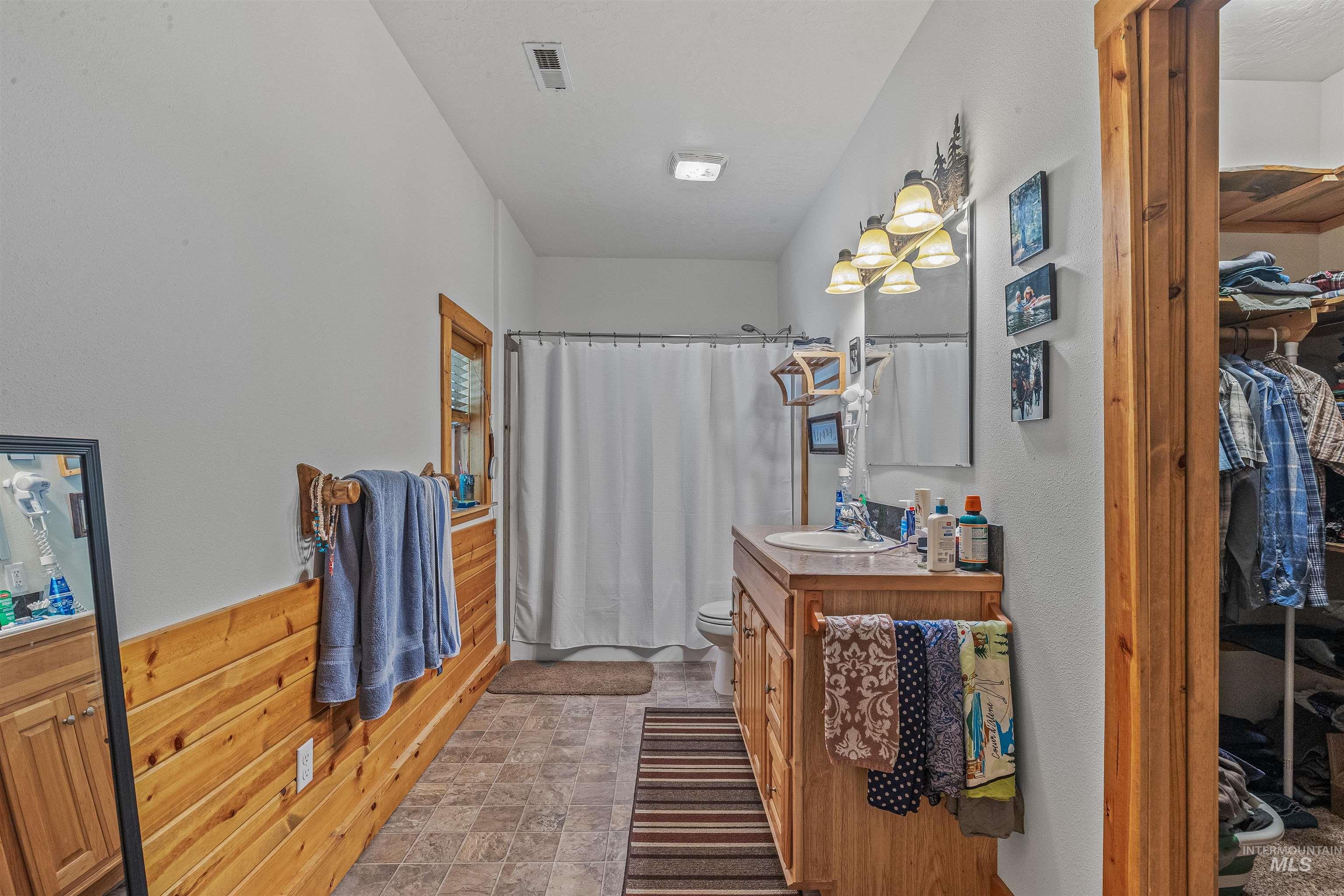 302 Berger Street Riggins, ID 83549 - Photo 36 of 47 Full bathroom featuring vanity, curtained shower, and a walk in closet