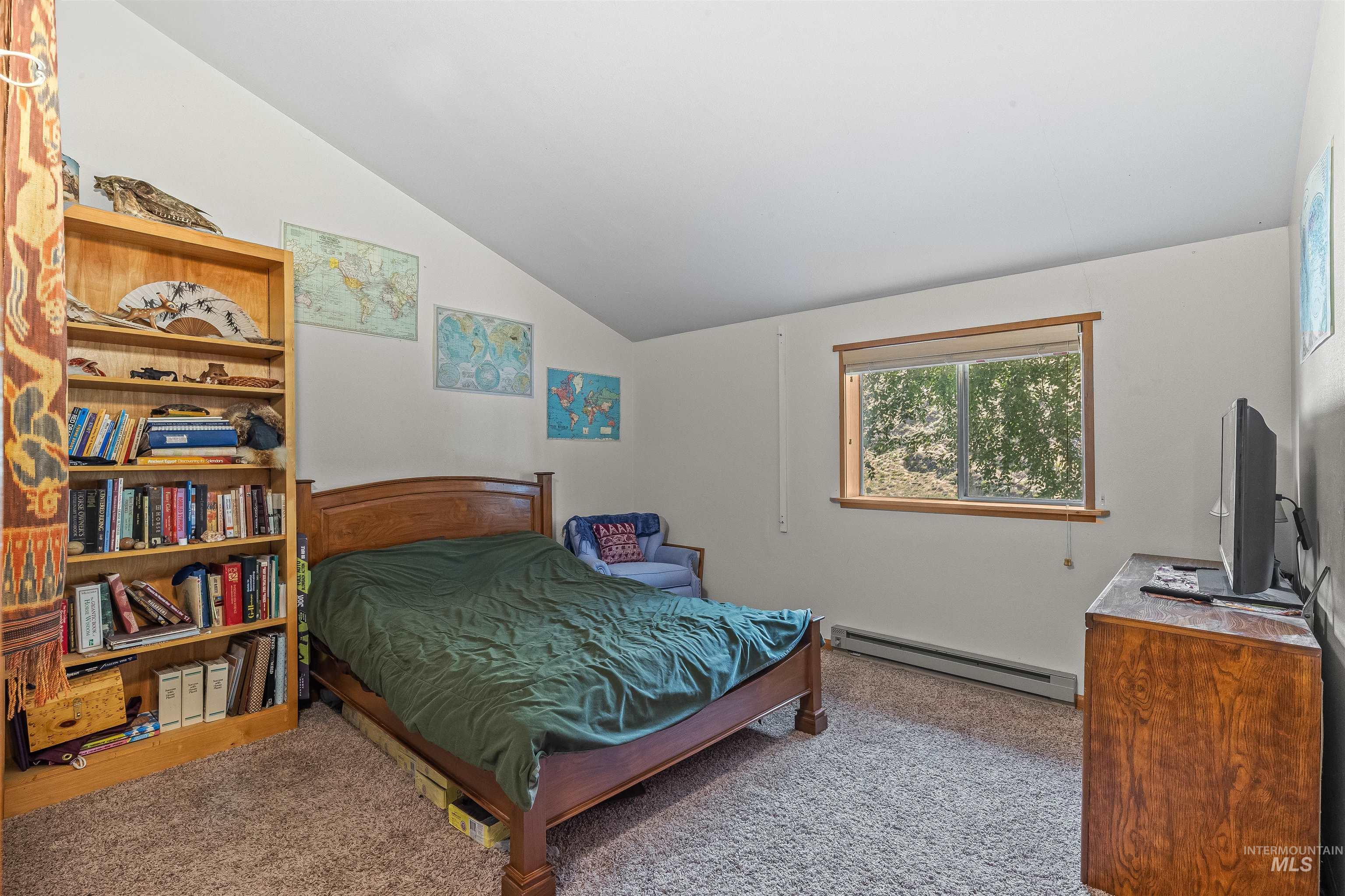 302 Berger Street Riggins, ID 83549 - Photo 10 of 47 Carpeted bedroom featuring a baseboard radiator and lofted ceiling