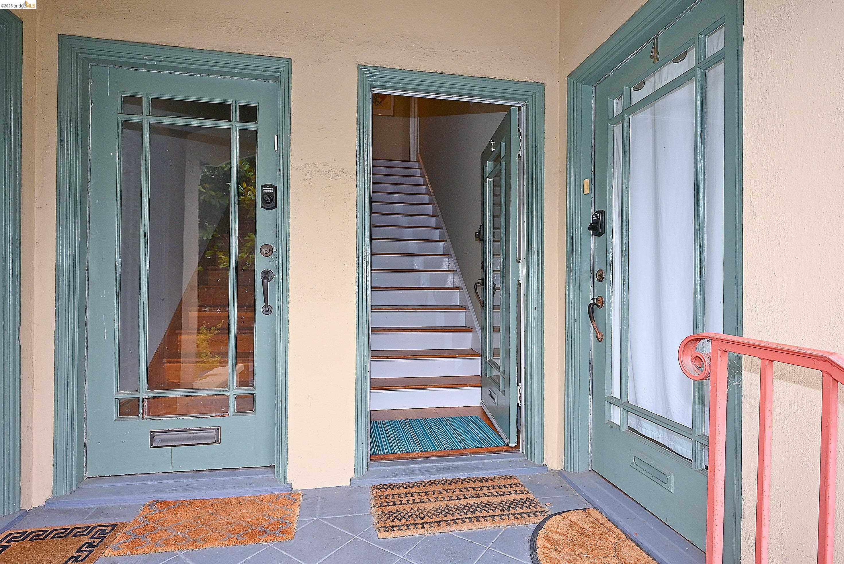 1301 Bonita Avenue, Unit 3 Berkeley, CA 94709 - Photo 3 of 48 Entryway featuring three paneled doors with glass inserts, two of which are painted a muted teal