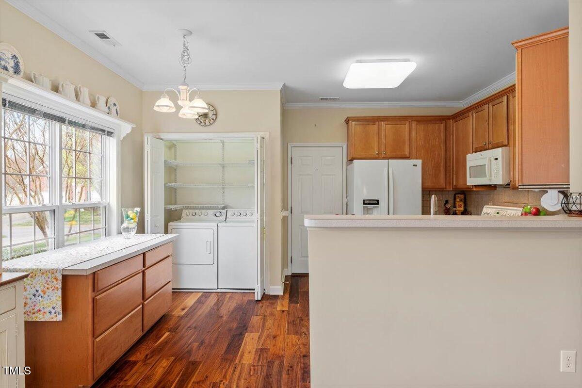2524 Forest Shadows Lane Raleigh, NC 27614 - Photo 14 of 48 a kitchen with a refrigerator a sink dishwasher a stove and white cabinets with wooden floor