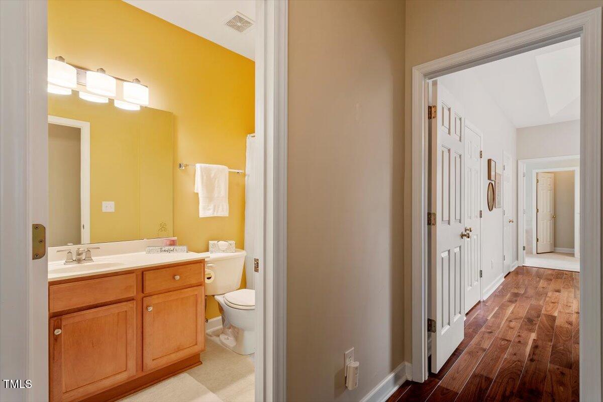2524 Forest Shadows Lane Raleigh, NC 27614 - Photo 23 of 48 a bathroom with a sink a toilet and a mirror