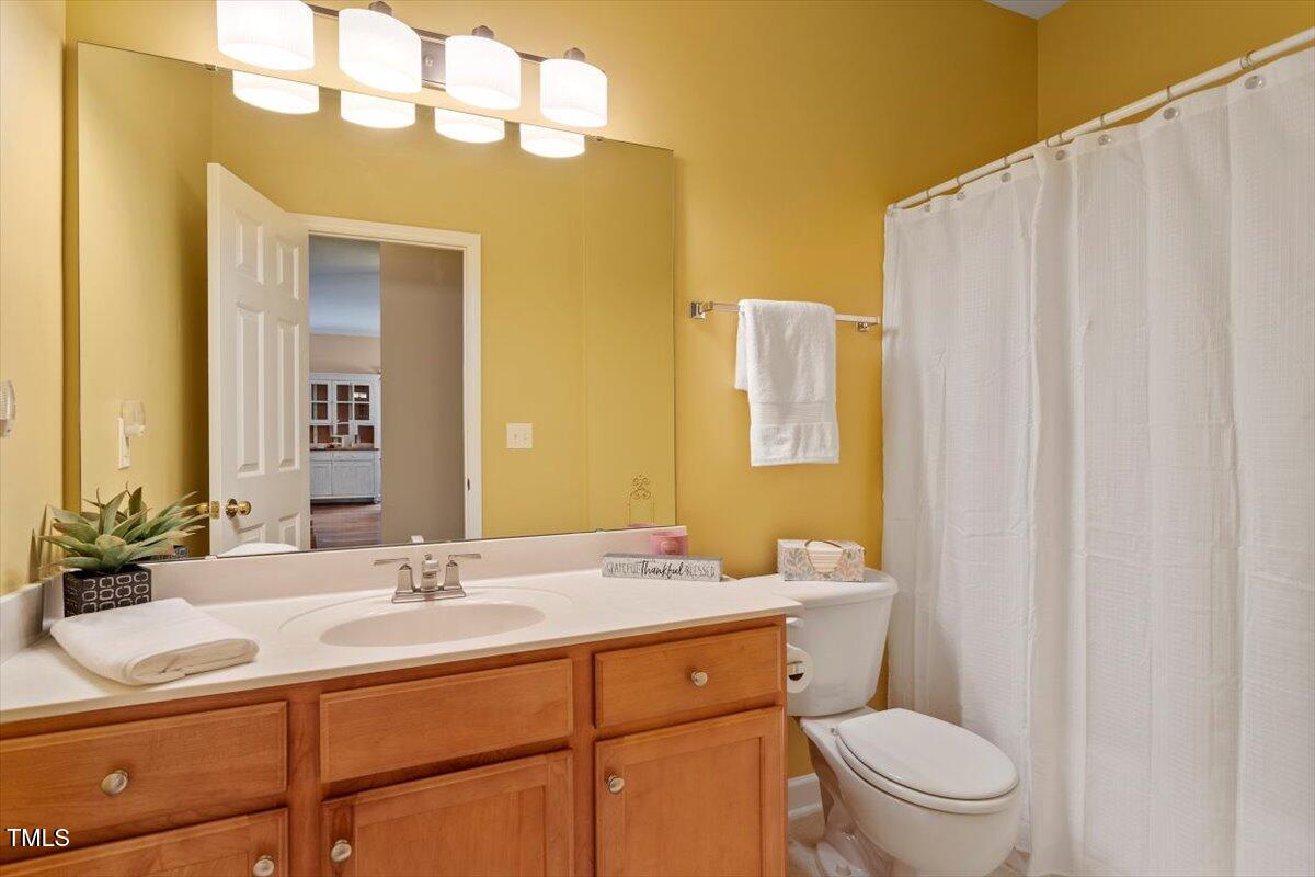 2524 Forest Shadows Lane Raleigh, NC 27614 - Photo 24 of 48 a bathroom with a sink a toilet and shower