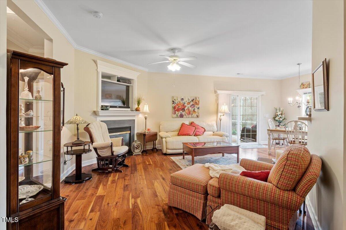 2524 Forest Shadows Lane Raleigh, NC 27614 - Photo 6 of 48 a living room with furniture fireplace and a flat screen tv