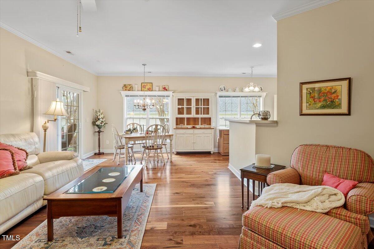 2524 Forest Shadows Lane Raleigh, NC 27614 - Photo 7 of 48 a living room with furniture and a wooden floor
