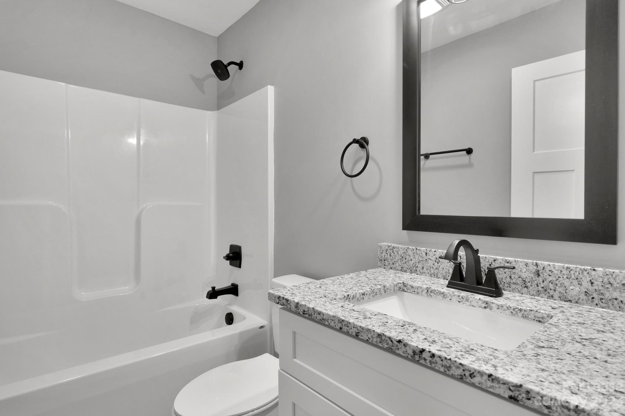 385 Roper Drive Lincolnton, NC 28092 - Photo 11 of 13 a bathroom with a granite countertop sink toilet and shower
