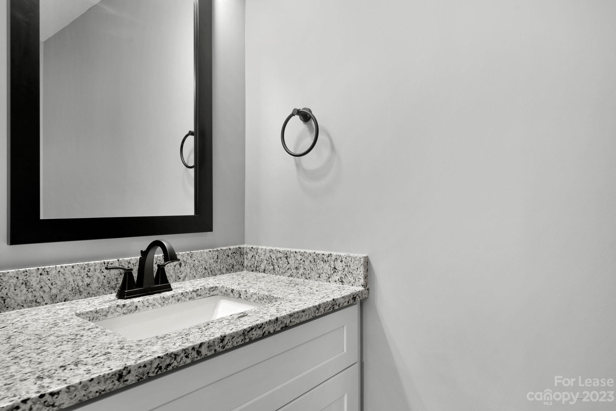 385 Roper Drive Lincolnton, NC 28092 - Photo 12 of 13 a bathroom with a granite countertop sink and a mirror