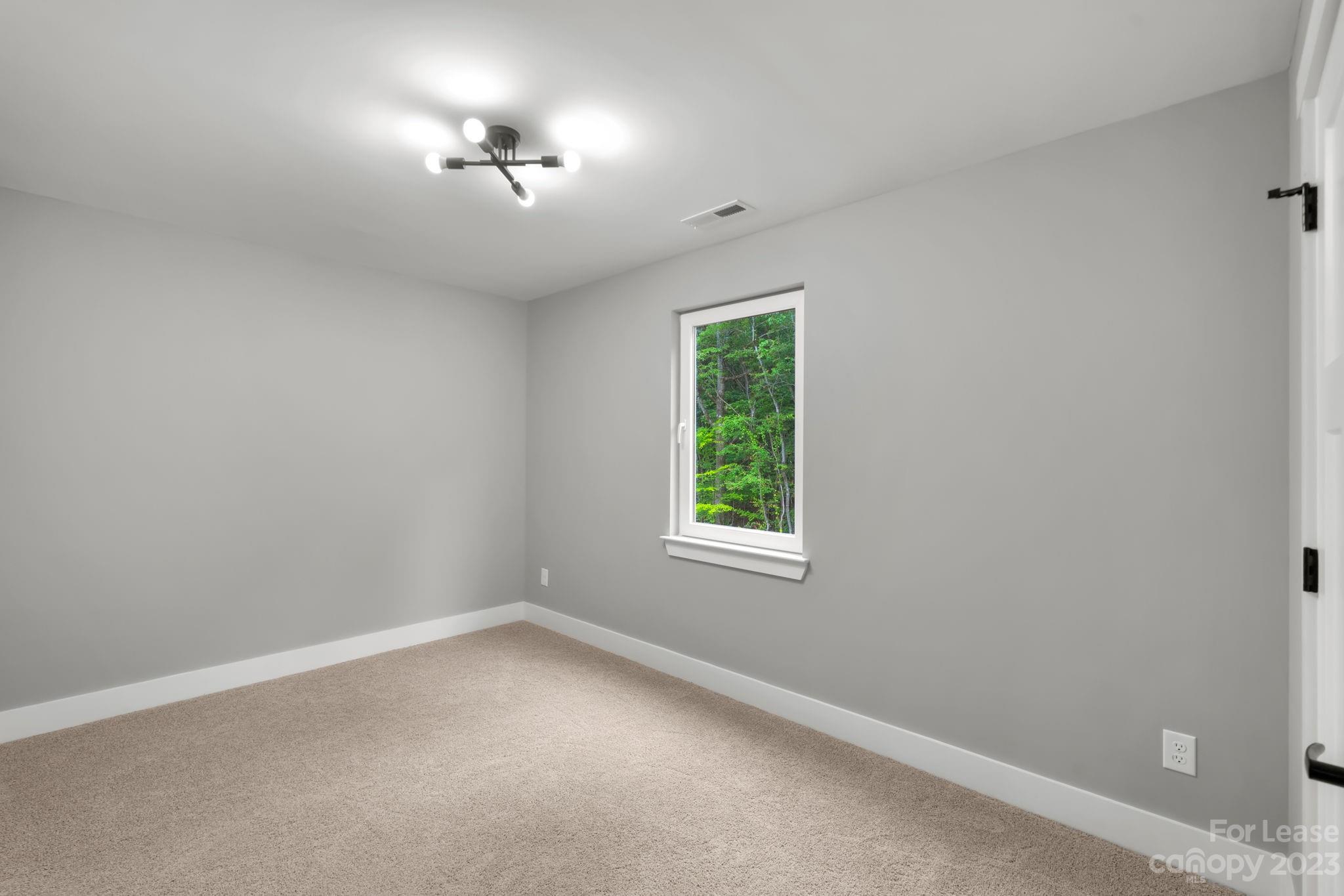 385 Roper Drive Lincolnton, NC 28092 - Photo 6 of 13 an empty room with a window and a fan