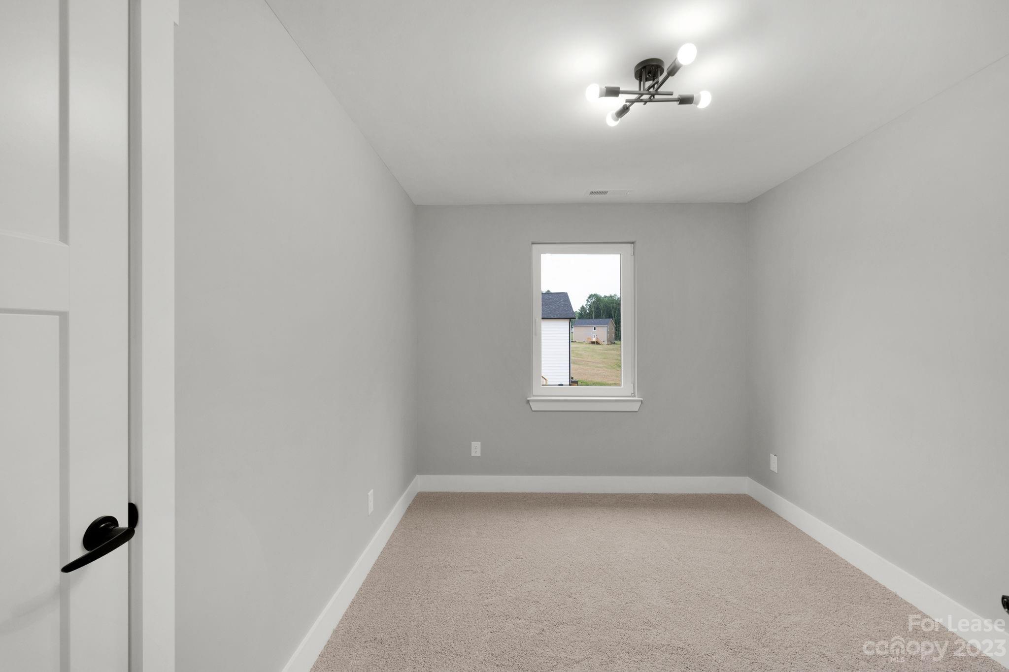 385 Roper Drive Lincolnton, NC 28092 - Photo 7 of 13 an empty room with a window