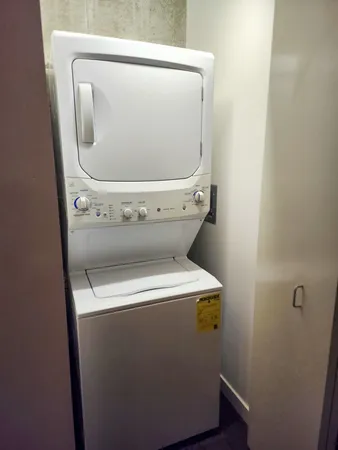 a white toilet sitting next to a white sink and vanity