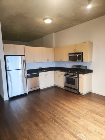 a kitchen with stainless steel appliances and wooden cabinets