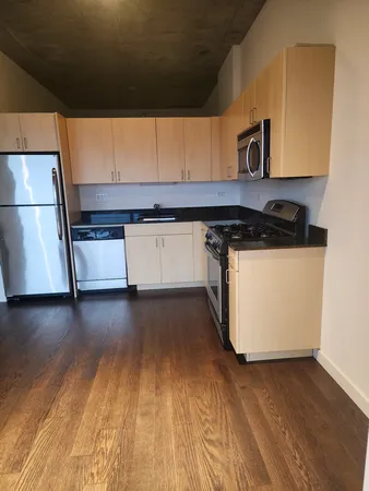 a kitchen with wooden floors and a sink