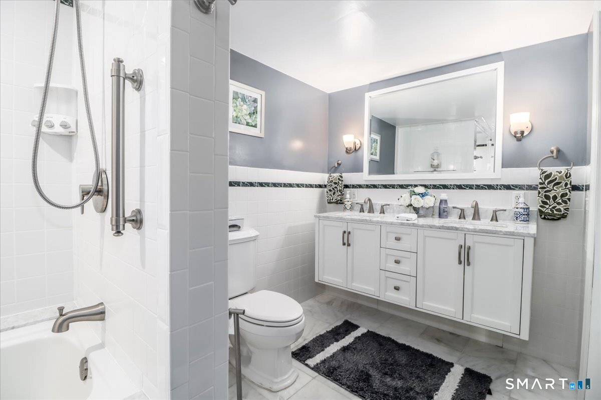 4 Farrell Road Newtown, CT 06470 - Photo 12 of 36 a bathroom with a toilet sink and mirror